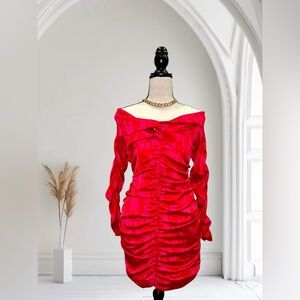 Red satin dress with long sleeves. Off the shoulder neckline. Ruched design.